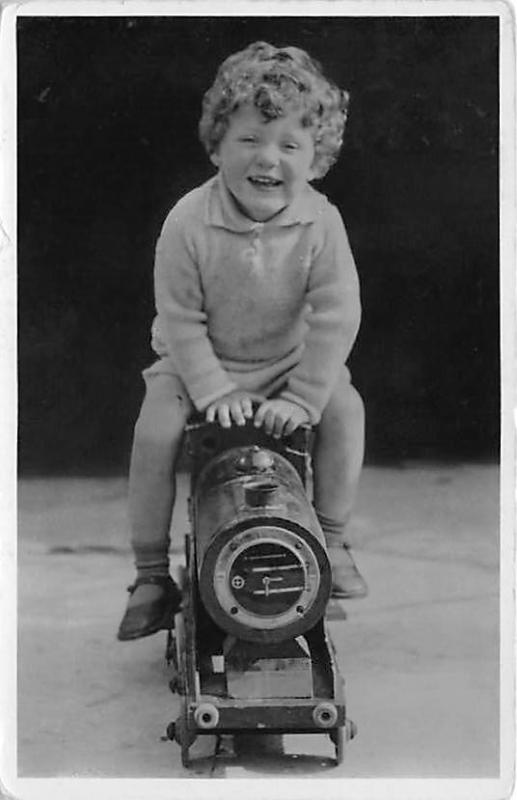 Little kid on toy train Child, People Photo 1937 Missing stamp 