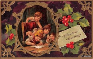 AH110 Framed children's band holly edging c 1910 Christmas postcard