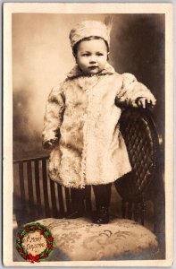 A Merry Christmas Baby Girl Photograph Standing On A Chair Postcard