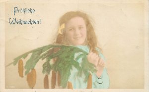 Girl holding brunch of pine cones tree Christmas greetings Germany Leipzig 1905