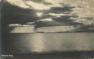 RPPC Postcard Manila Bay With Ship silhouette in Distance Postmarked Philippines