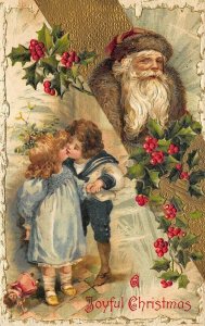 Joyful Christmas Red Suited Santa Claus Boy Girl Kissing Postcard