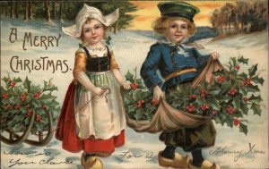 Christmas Cute Little Dutch Boy and Girl Gather Holly c1910 Vintage Postcard