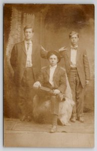 RPPC Three Young Men Seated Fur Rug Studio Photo Postcard U28