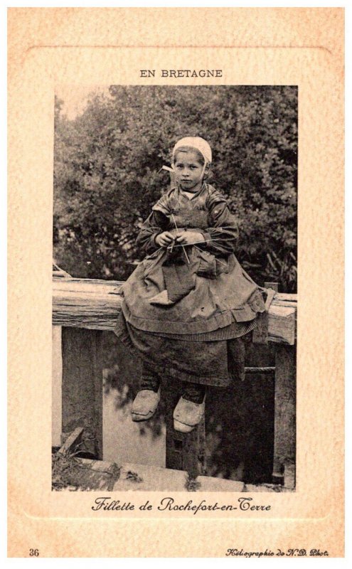 Breton Girl  knitting sitting on bridge