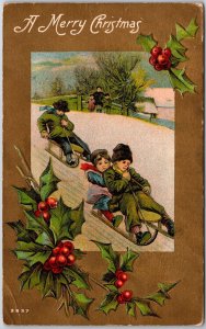 1909 A Merry Christmas Winter Snow Children Slide Green Leaves Posted Postcard