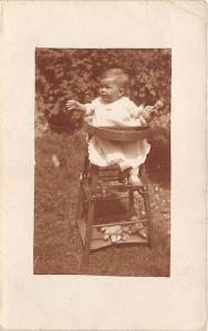 Little baby in high chair Child, People Photo Writing on back very light crea...