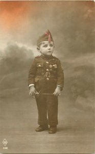 Lovely little boy dressed as a decorated military soldier uniform early postcard