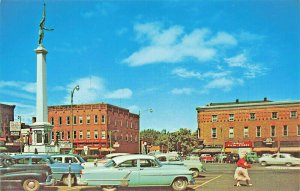 Angola IN City Square Monument Storefronts Old Cars Postcard