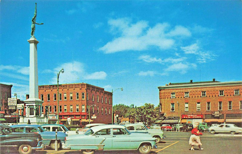 Angola IN City Square Monument Storefronts Old Cars Postcard