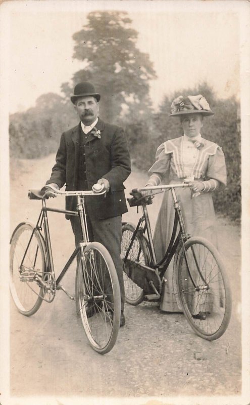 DISTINGUISHED DRESSED MAN & WOMAN WITH BICYCLES~BRITISH PHOTO POSTCARD