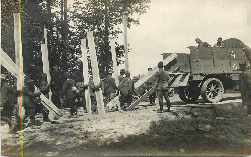 Postcard RPPC C-1918 Soldiers Trucks wooden planks construction Military 23-1693