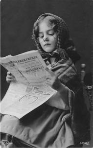 Young girl reading the newspaper Child, People Photo Unused 