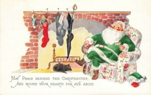 Christmas Green Suited Santa Claus Relaxing Fireplace Embossed Postcard