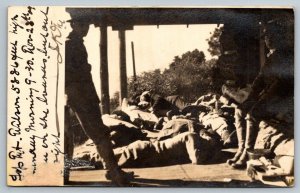 RPPC  US Army Soldier with Dead or Sleeping People?  Postcard