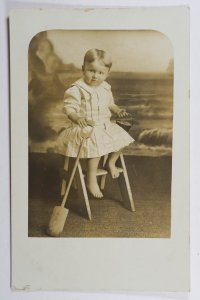 Child Portrait with Spade & Beach Background - Real Photo Postcard  (b4)