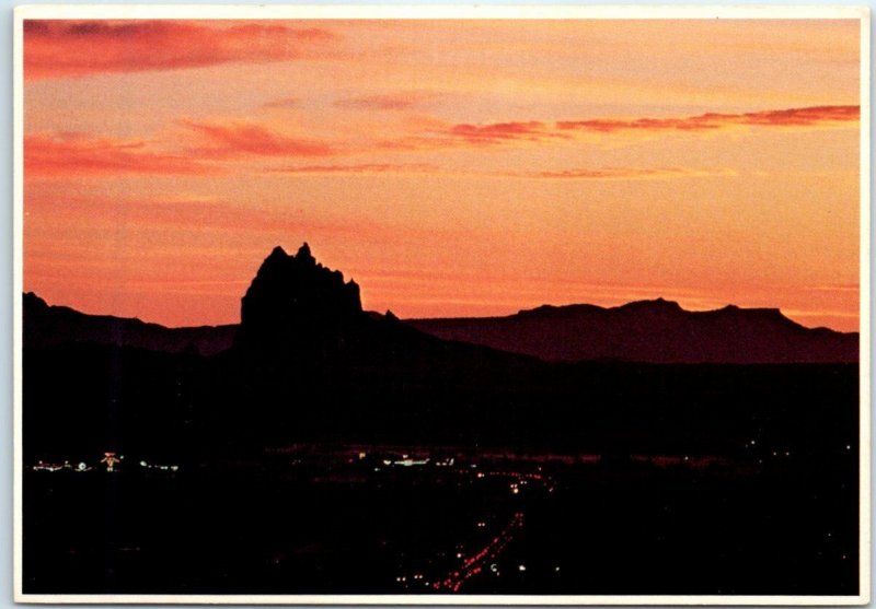Sunset silhouettes the giant Shiprock formation Shiprock, New Mexico