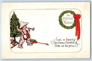 c1910's Christmas Greeting Boy Blowing Horn Wagon Toy Wreath Berries Postcard