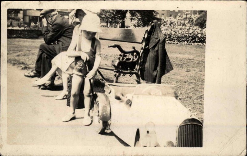 Little Boy Pretends to Change Tire on His Pedal Car Real Photo Postcard