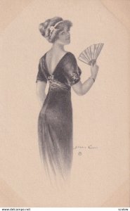 AS: Pretty woman in dark gown holding hand fan looking over shoulder, 1900-10s
