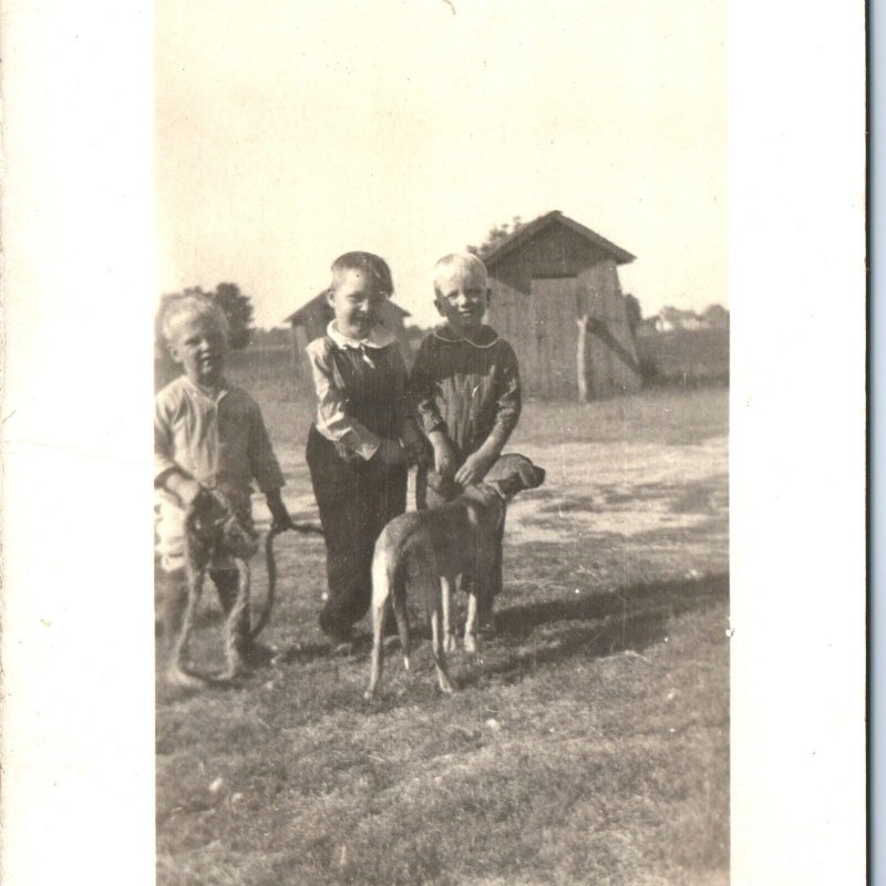 c1920s Cute Dog Handsome Little Boys RPPC Outdoors Play Farm Outhouse Photo A142