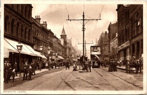 VINTAGE POSTCARD STREET SCENE PEOPLE STORES TROLLEY BUS BRIGGATE LEEDS UK 1910