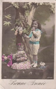 RP: NEW YEAR, 1910-20s; Children by a tree and flowers