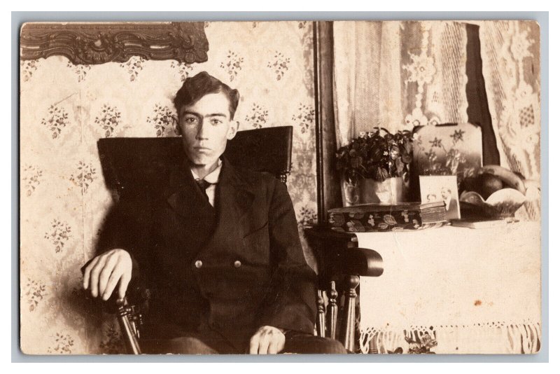 Postcard Young Man Sitting In Chair Worried Look On Face RPPC 