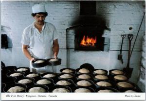 Baker Preparing soldiers' bread in brick oven at Old Fort Henry Kingston Ontario