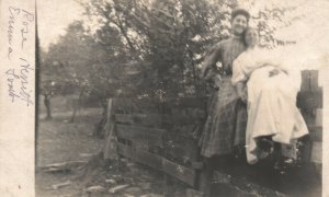 Vintage Postcard 1910's RPPC Women in Dresses Sitting on Fence Portrait Photo