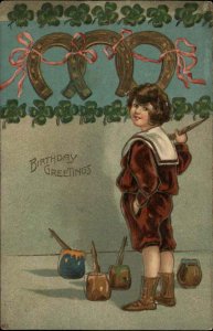 Birthday Child Paints Horseshoes Clovers Embossed c1900s-10s Postcard