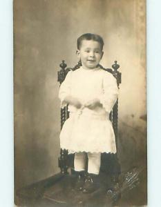 Pre-1918 rppc CHILD ON ANTIQUE CHAIR EMBOSSED BY STUDIO Sioux City IA t2373