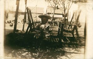 YOUNG CHILD WITH HAT RIDING TRICYCLE REAL PHOTO RPPC POSTCARD c1910