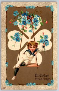 EAS~Boy In Sailor Suit On Wooden Swing Holds Flowers~GEL~c1910 Vintage Postcard