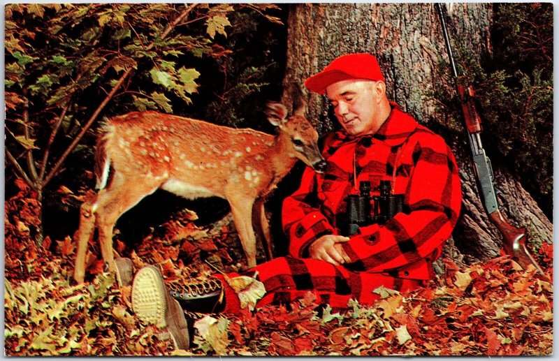 VINTAGE POSTCARD HUNTER WITH BINOCULARS AND RIFLE RESTING AT TREE WITH FAWN DEER