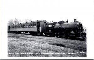 Real Photo Postcard Cadillac and Lake City Railway Train in Lake City, Michigan