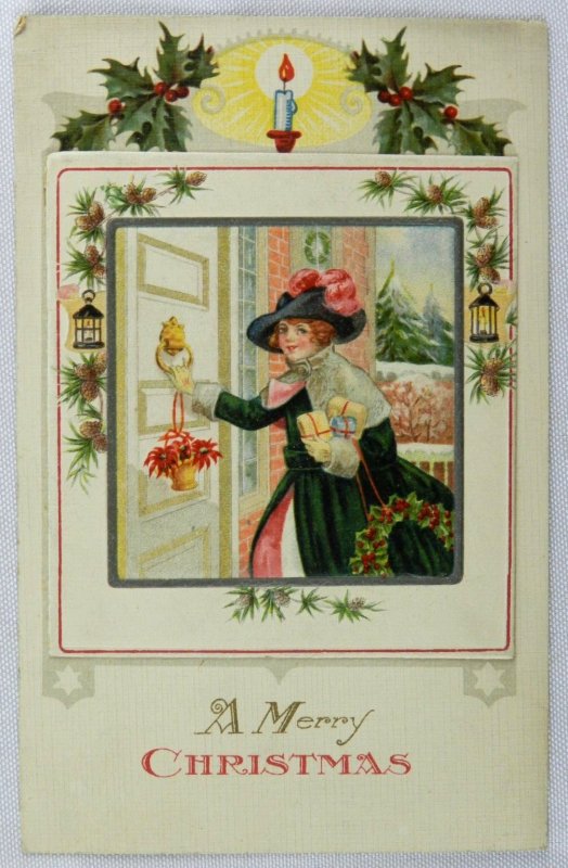 Young Woman in Long Coat Carries Wreath Knocking At Door - Vintage Postcard
