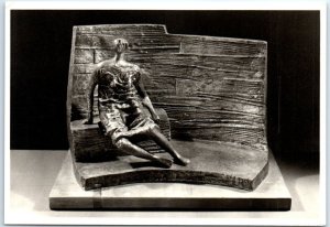 Bronze: Draped seated figure against curved wall, Fitzwilliam Museum - England