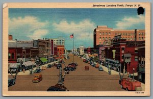 Postcard Fargo ND c1943 Broadway Looking North Luger Furniture Co Shops Old Cars