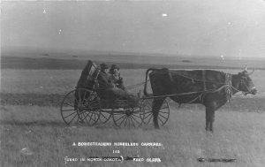 c1910 North Dakota Homesteaders Horseless carriage Olsen RPPC Postcard 25-10869