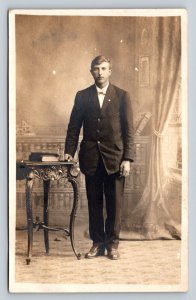 RPPC Man in Suit w/Bow Tie Posing by Table AZO 1904-1918 ANTIQUE Postcard 1472