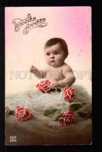 3034270 Little Boy in Roses. Old Tinted Photo