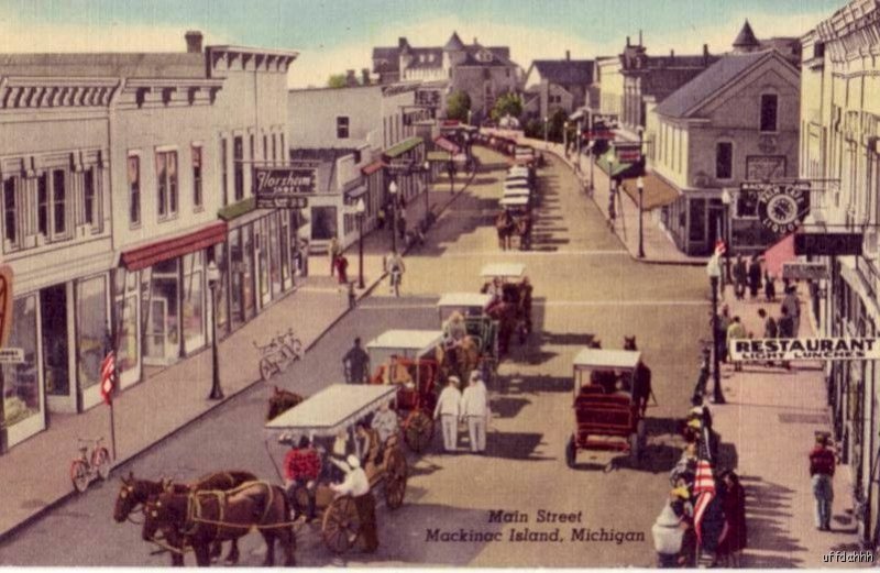 VISITORS ENJOY CARRIAGE RIDES ALONG MAIN STREET MACKINAC ISLAND, MI  1954