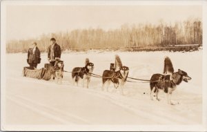 Dog Team Sled near Fort McMurray Alberta AB Man Woman Huskies RPPCPostcard H33