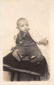 Young child sitting on a pillow David Bartholio Jr