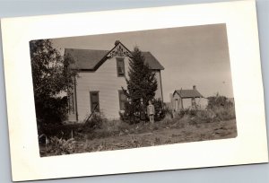 RPPC Dressed up Mother Father Son in front of house