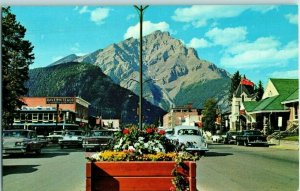 Main Street Canadian Rockies Floral Planters Dave White Co Old Cars Postcard