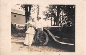 Lady and Man Standing by Car Old Automobile Real Photo Antique Postcard J69570