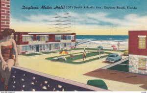 DAYTONA BEACH, Florida, 1957; Daytona Motor Hotel, Woman in swimsuit sitting ...