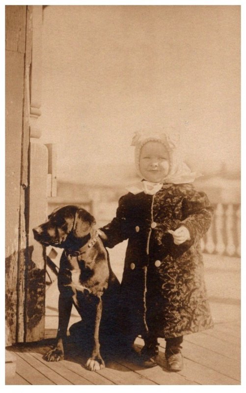 Child dressed Winter, with Dog